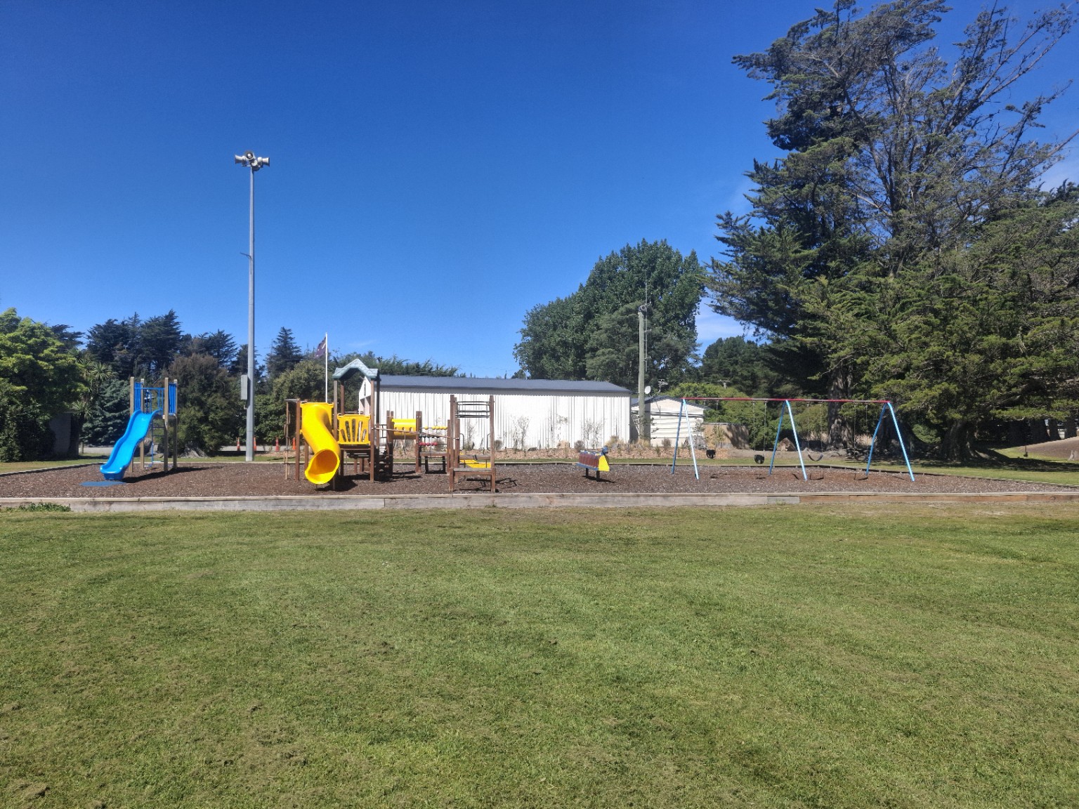 Playground at Waikuku Beach Oval, with slides and swings